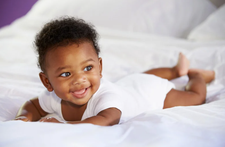 Happy smiling baby representing the meaning of the name Asher — blessed and joyful