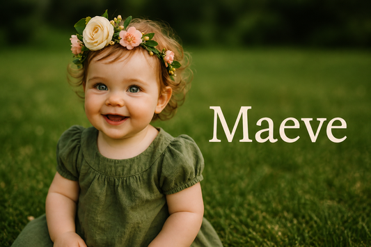 Smiling baby girl with a floral crown and green dress sitting on grass, with the name “Maeve” in elegant text beside her.