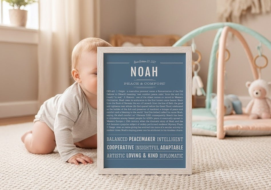 Baby crawling beside a framed Name Stories Noah personalized name print in a bright nursery, celebrating the Hebrew name meaning "rest," "comfort," and "peace."